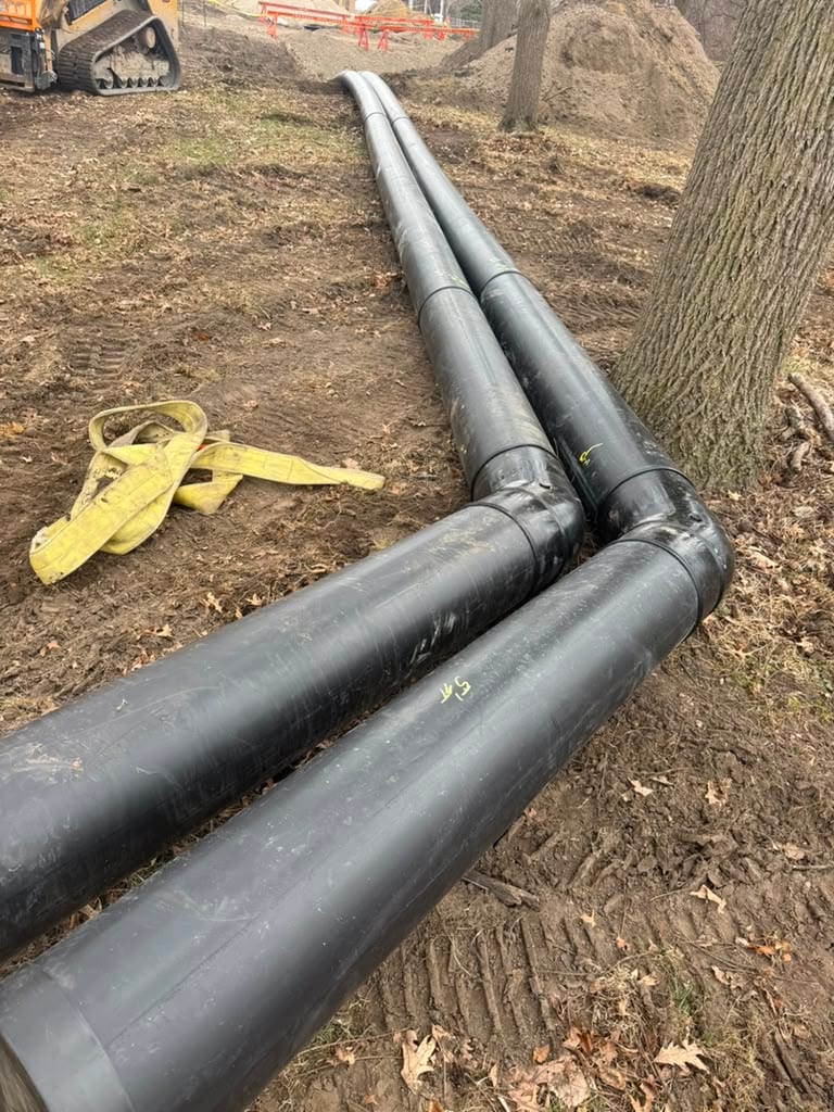 Fused HDPE pipe with fittings laid out on a job site