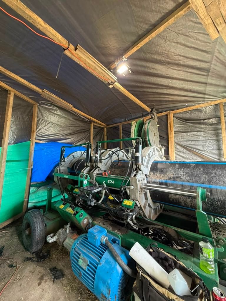 HDPE butt fusion machine set up under a shelter
